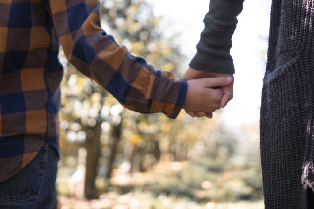 A mother and son holding hands